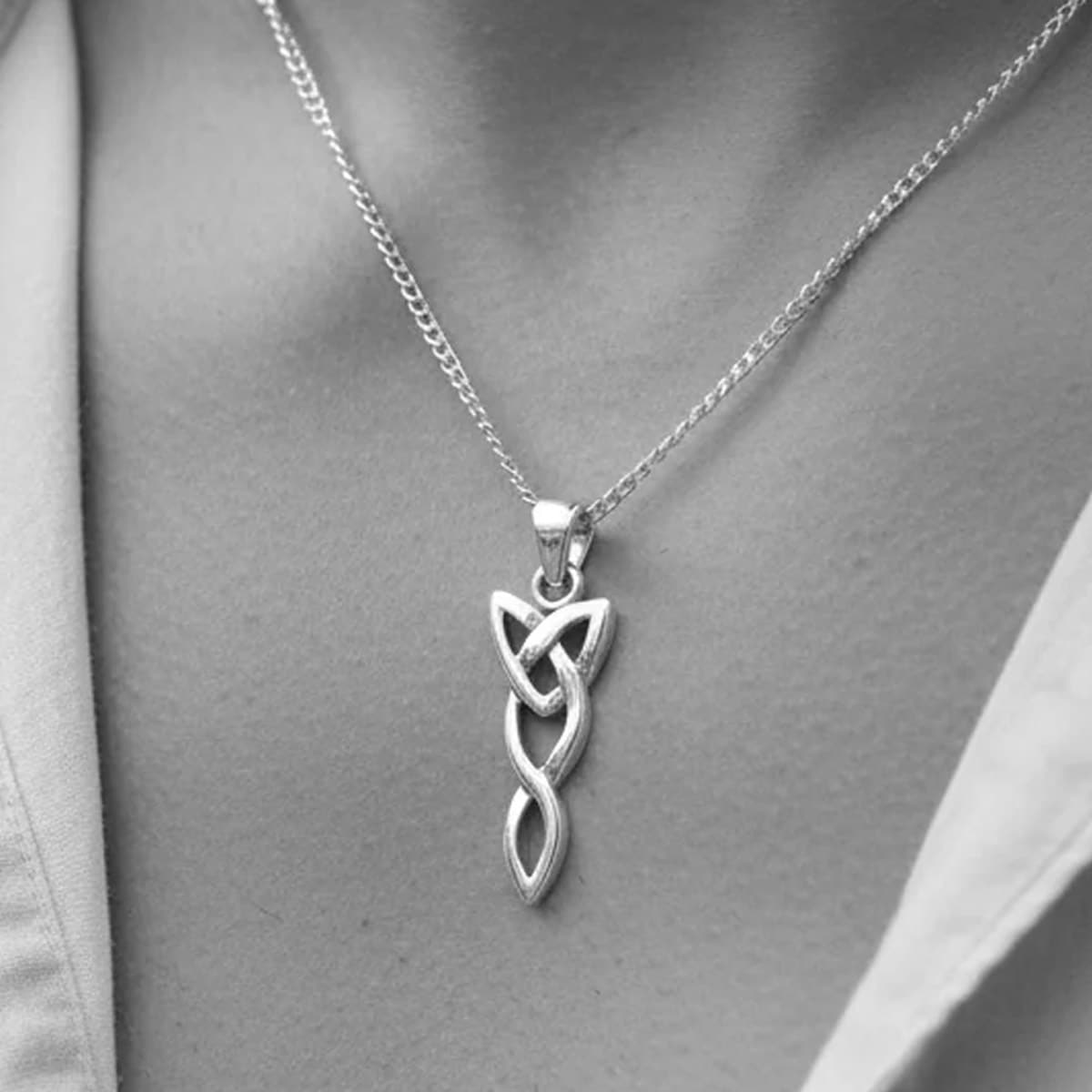 silver celtic trinity necklace on a man