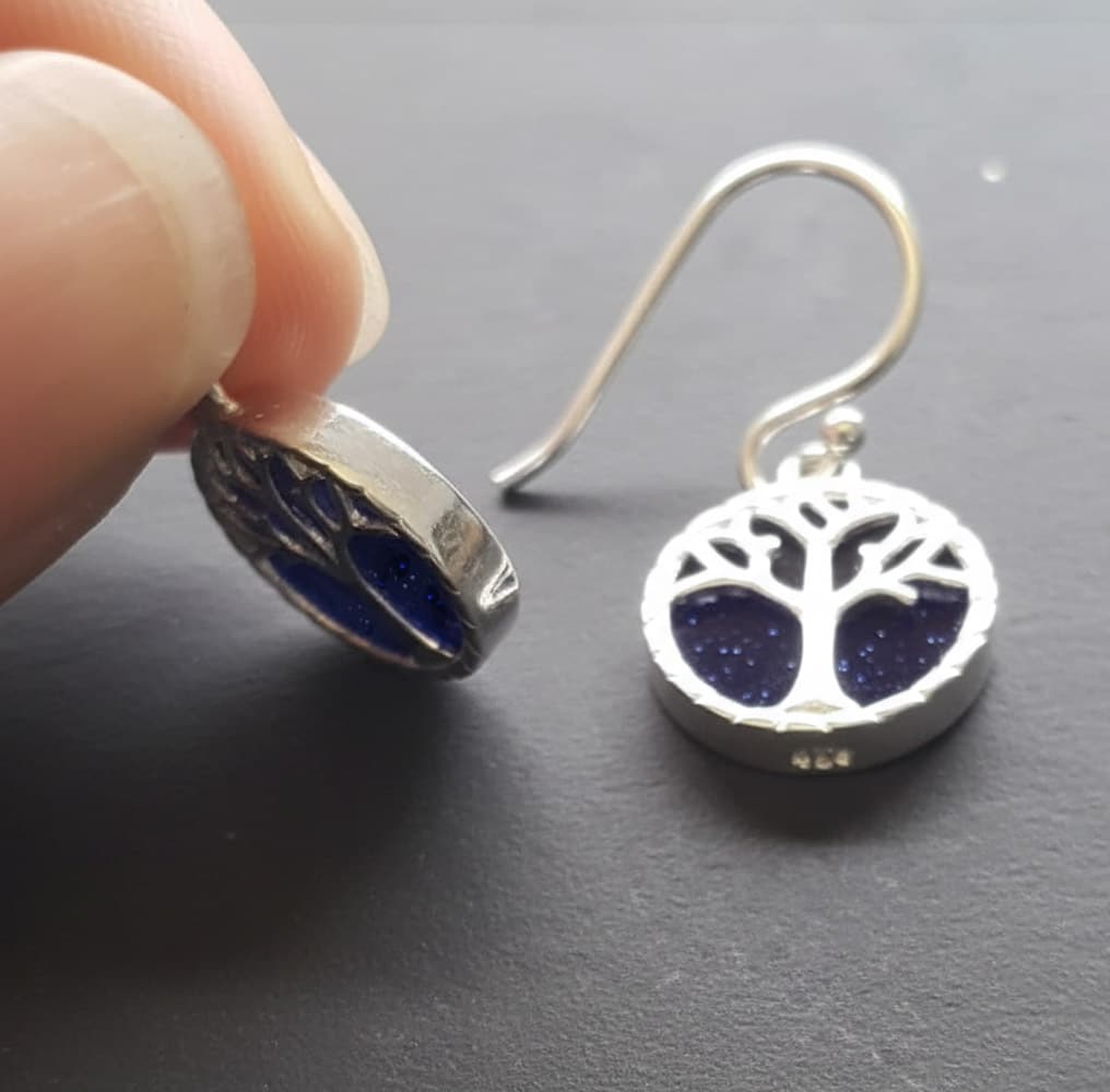 side profile of silver tree of life earrings with goldstone, showing the thickness and depth of the charms