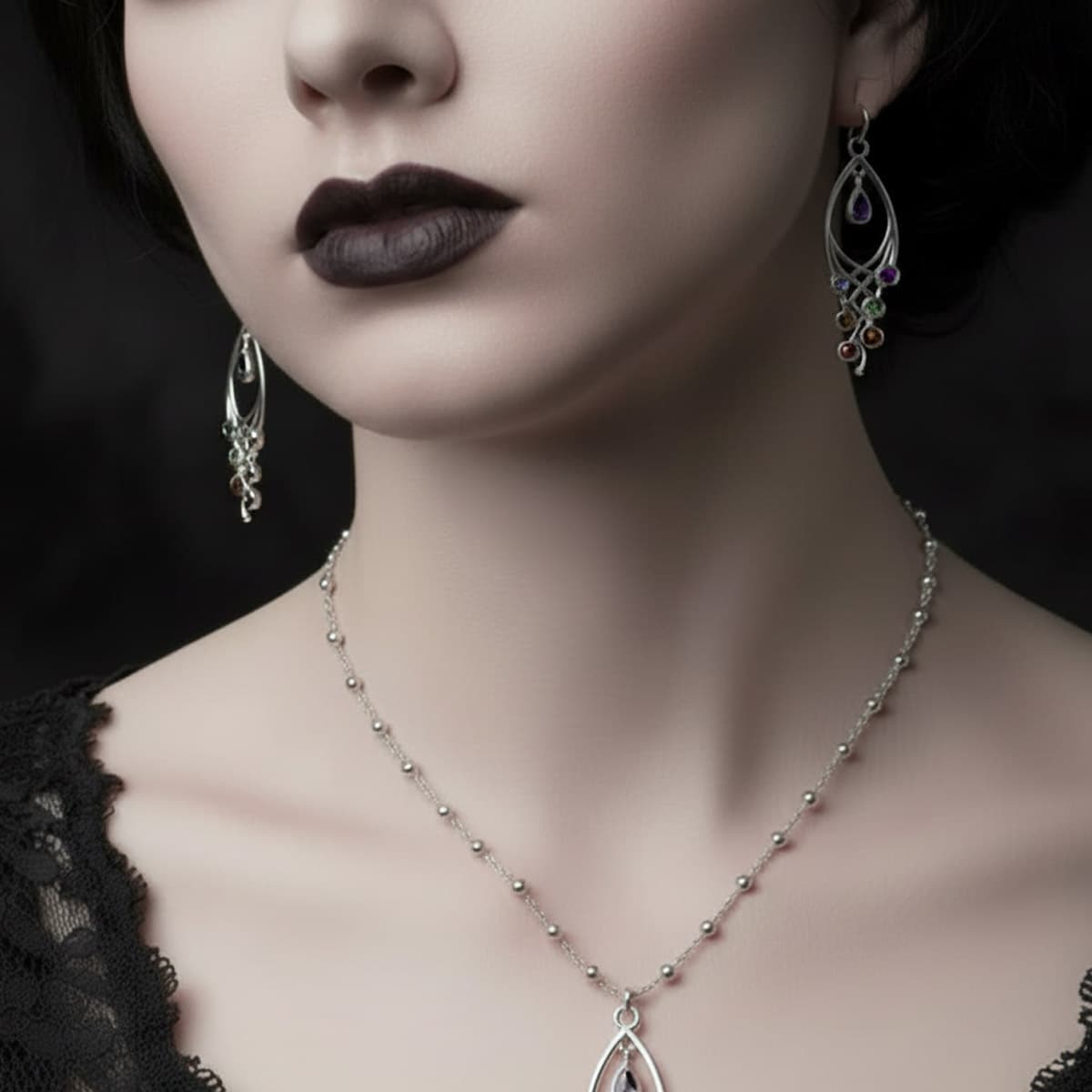 Close-up of vampire-chic lady wearing silver gothic crisscross gemstone earrings