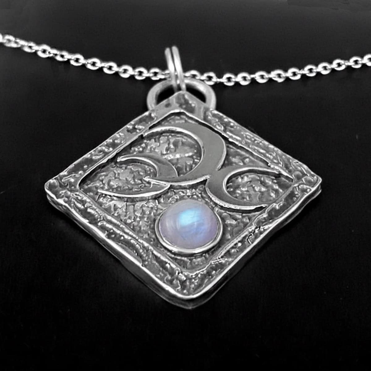 handmade gothic moon necklace with triple silver moons and a central rainbow moonstone