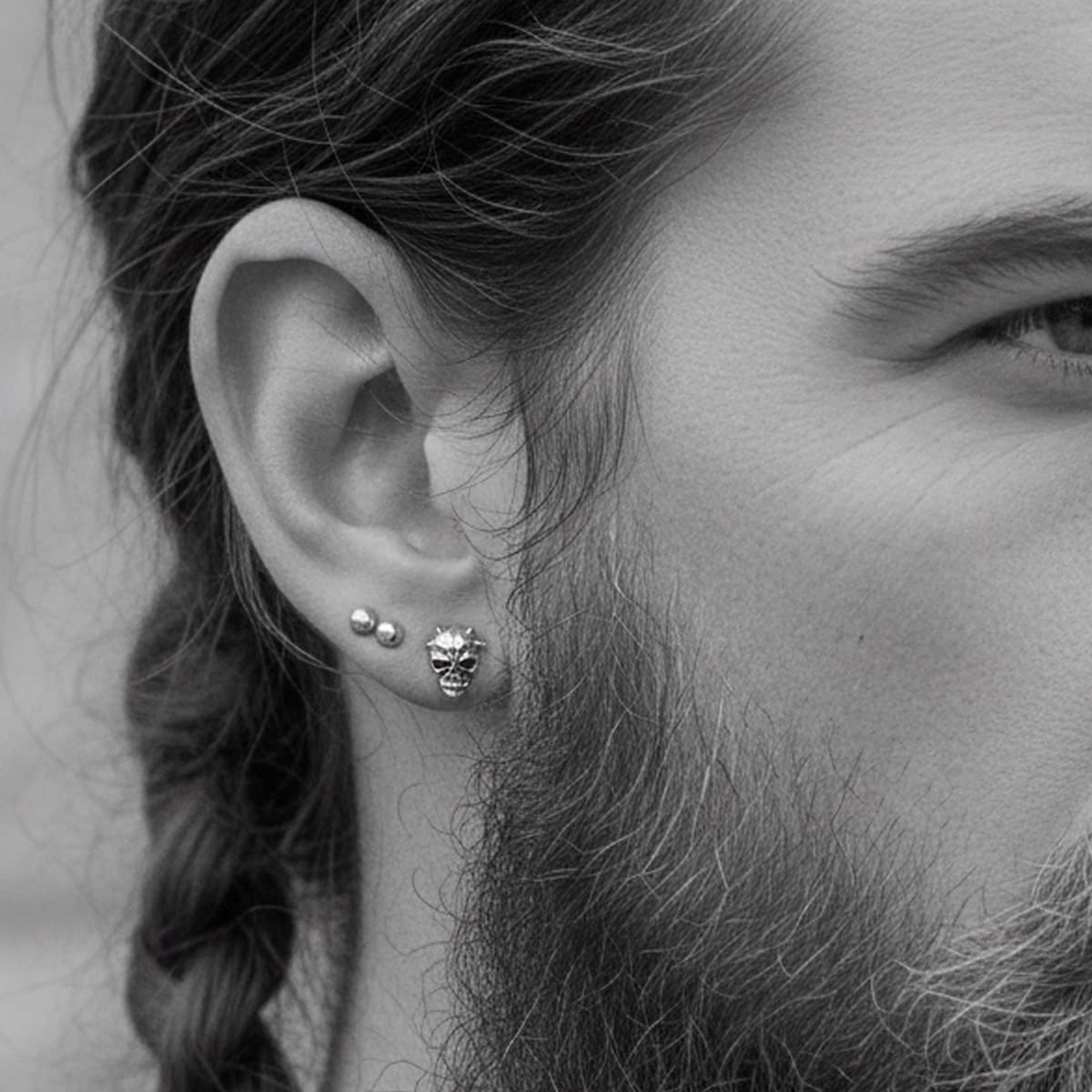 silver horned demon skull earring in biker mans ear