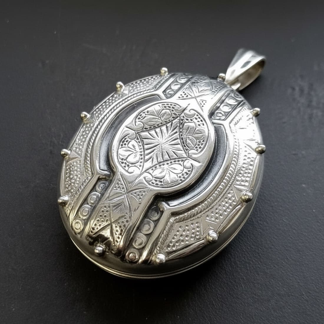 sterling silver Victorian gothic locket side profile showing rivet stud detail 