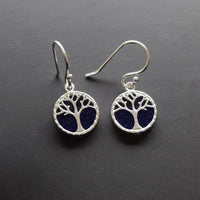 sterling silver earrings with tree of life design on dark behind to show the shimmering flecks of silver in the blue goldstone 