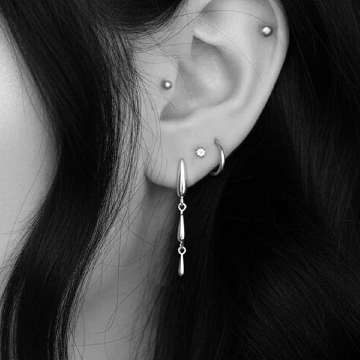 Cascade Gothic silver teardrop earrings close-up in ear of goth girl