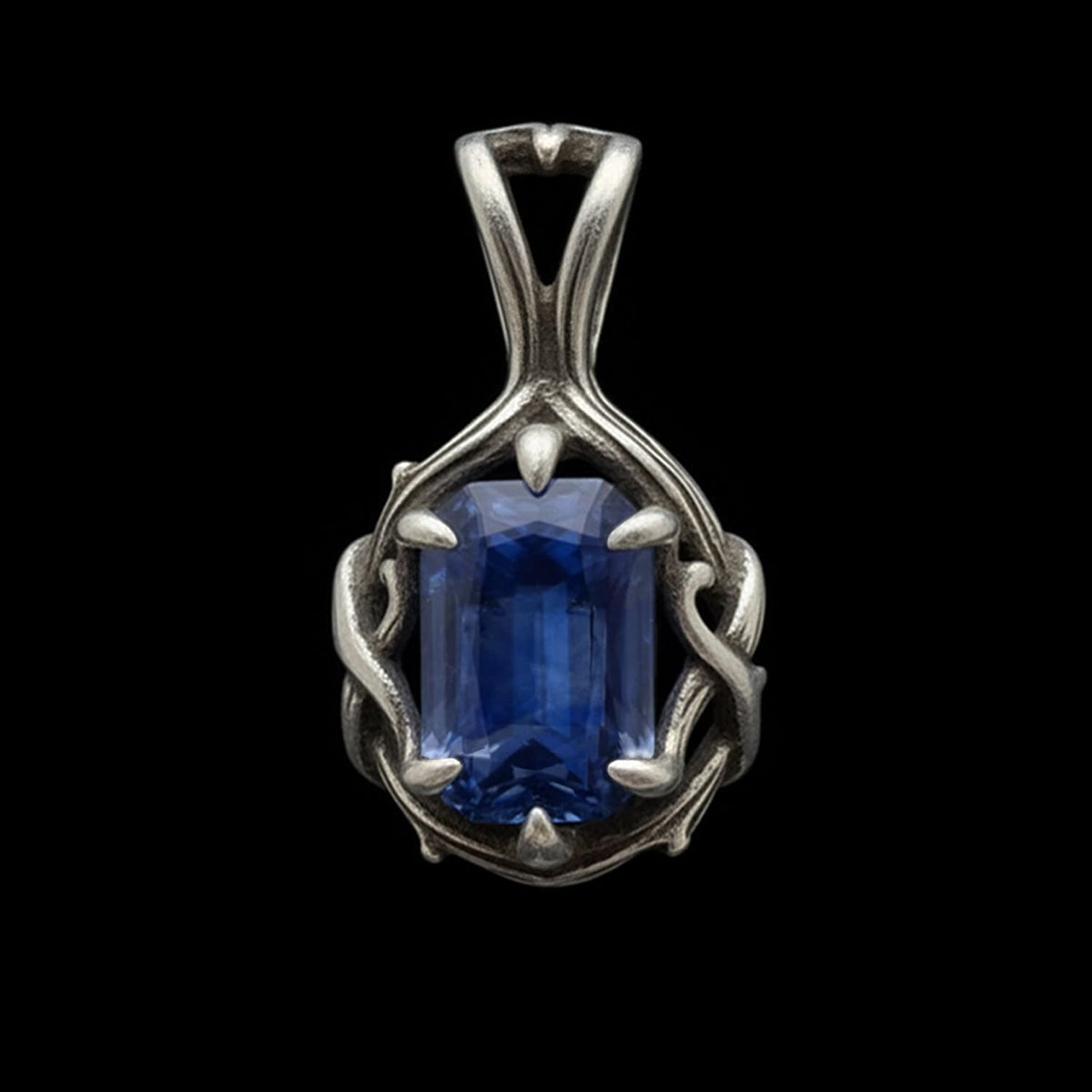 sterling silver luxury gothic pendant  the 'thorns of devotion' with a deep midnight sapphire stone held in the thorny claw like prongs